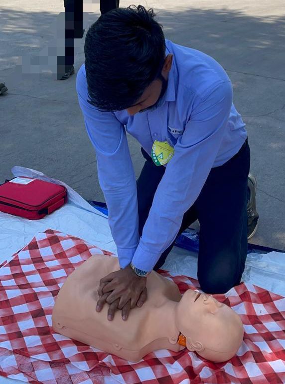 Participant performing chest compressions on a CPR mannequin