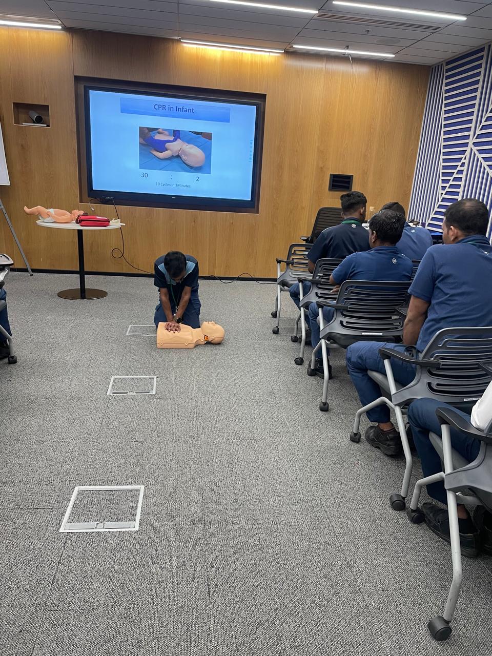 Infant CPR demonstration during a corporate training session
